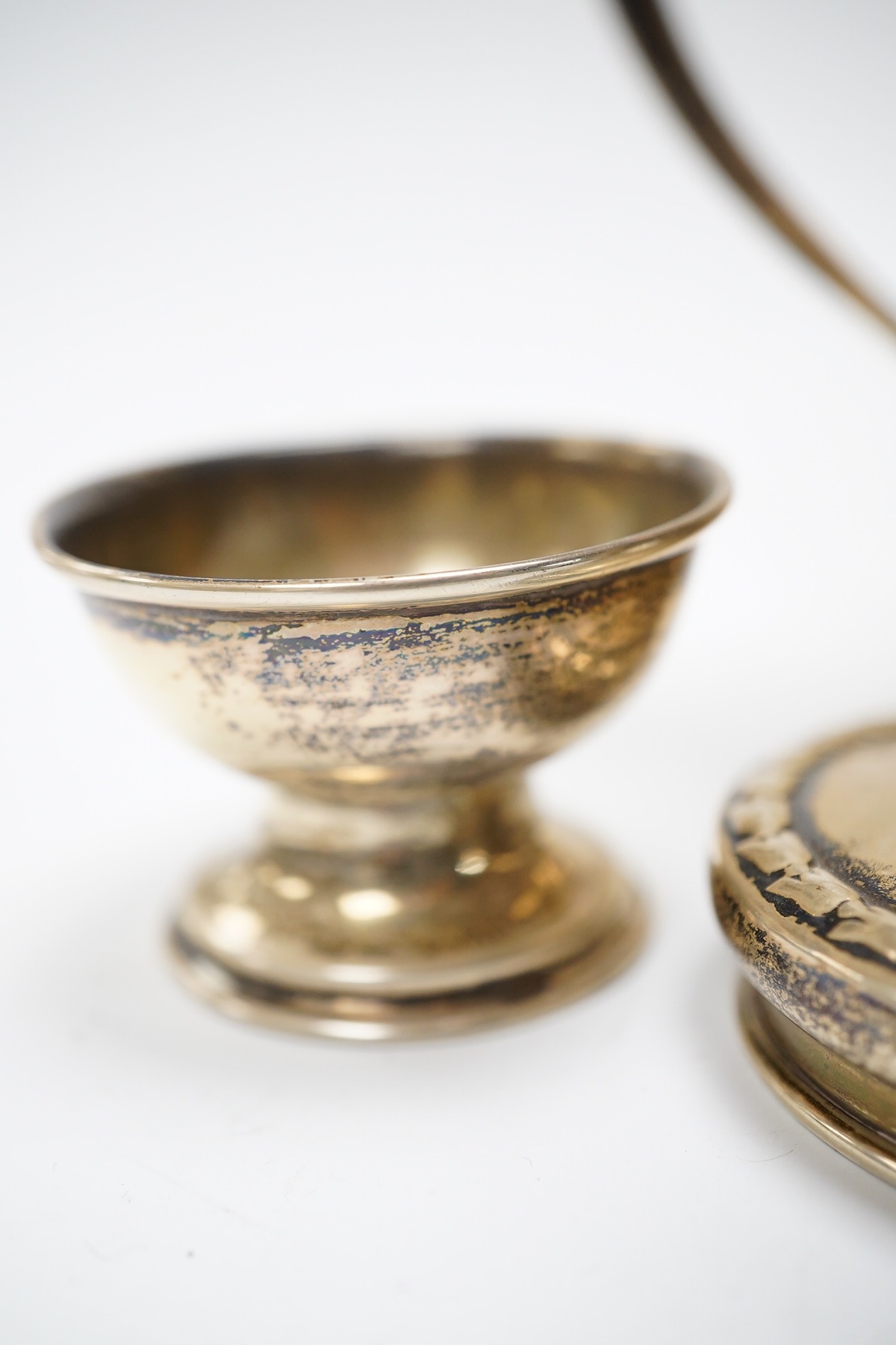 Six items of small silver:- two christening mugs, a cream jug, a salt, an egg cup and a box lid. Condition - poor to fair